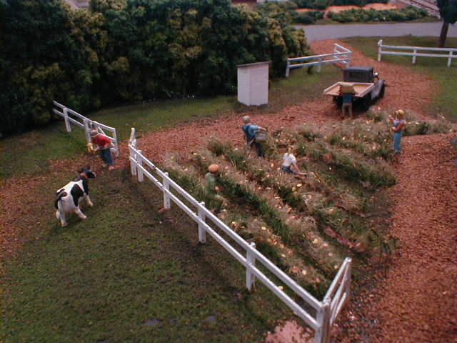 scale model farm fence and cow